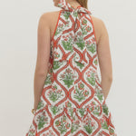 Woman wearing a patterned dress with a white background