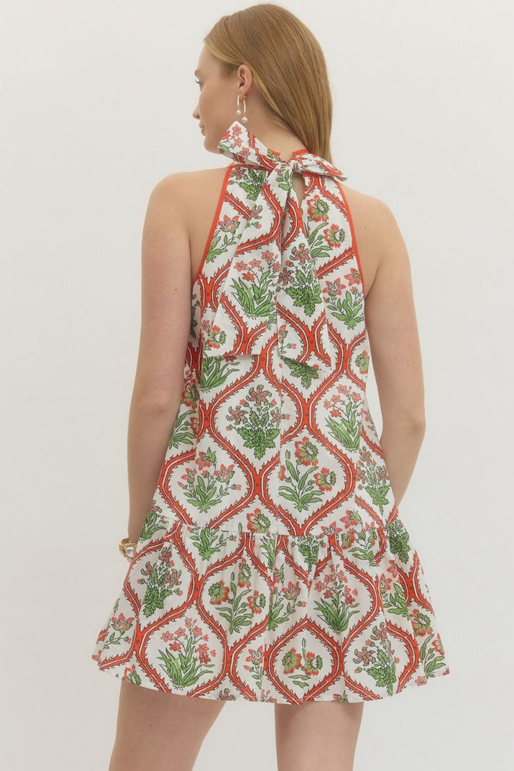 Woman wearing a patterned dress with a white background