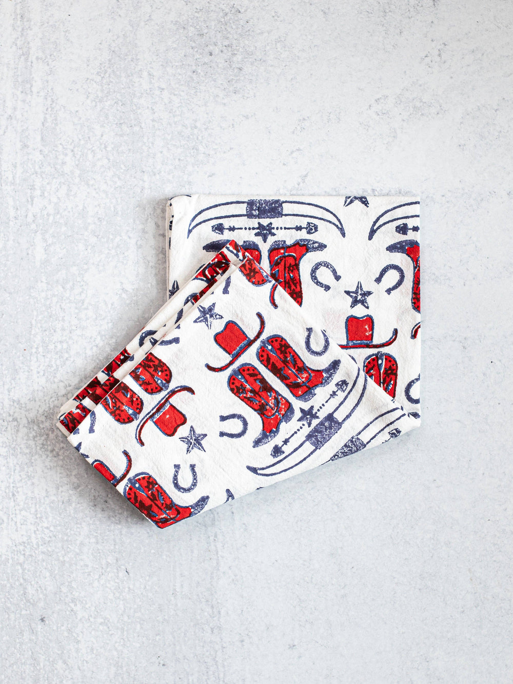 Two fabric pouches with cowboy pattern on a light gray background