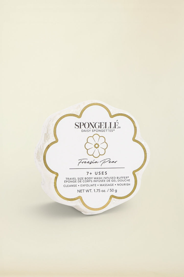 A white floral-shaped Spongelle product packaging with the brand name and product line 'Freesia Pear Daisy' prominently displayed.