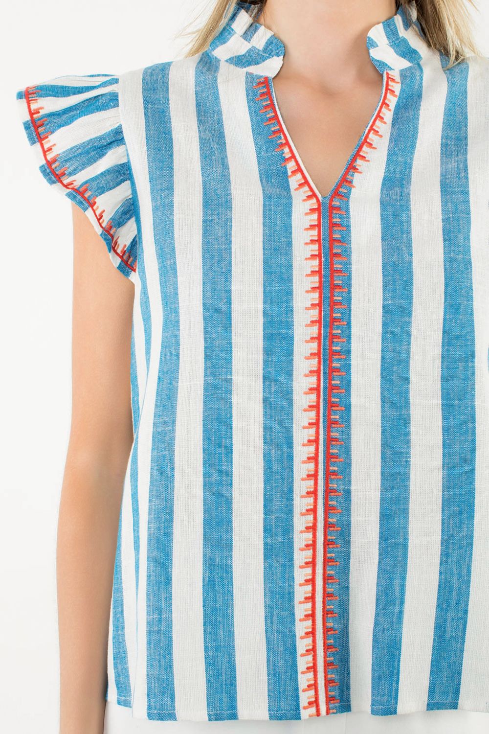 Blue and white striped top with red accents worn by a person