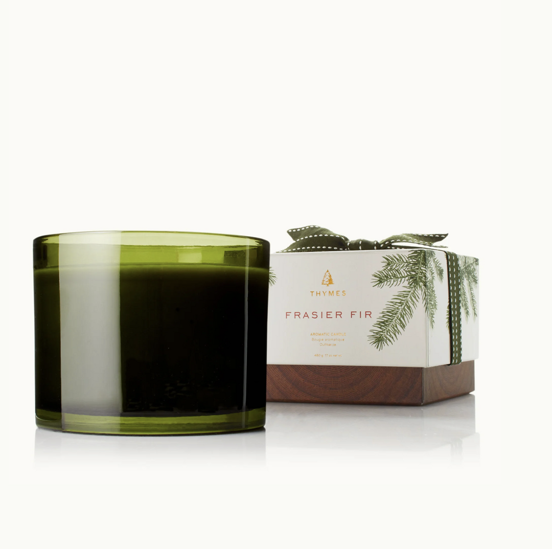 Green candle with a box labeled 'Frasier Fir' on a white background