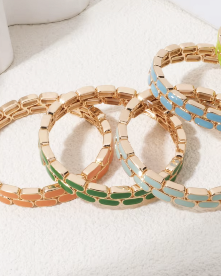 Set of colorful bracelets on a white surface