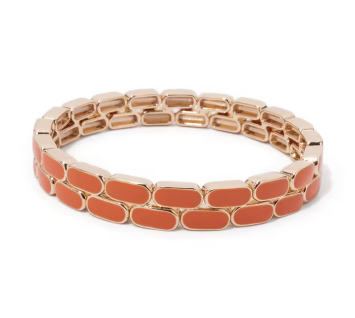 Orange bracelet with gold accents on a white background