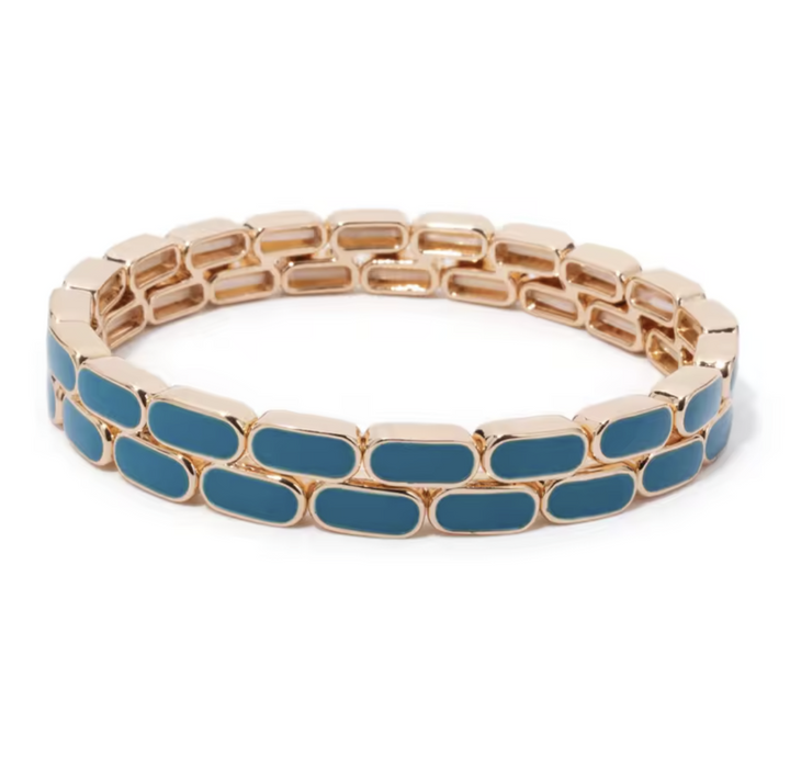 Gold bracelet with blue oval stones on a white background