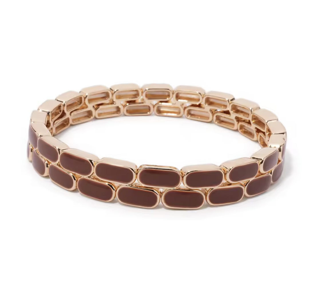 Rose gold and brown bracelet on a white background