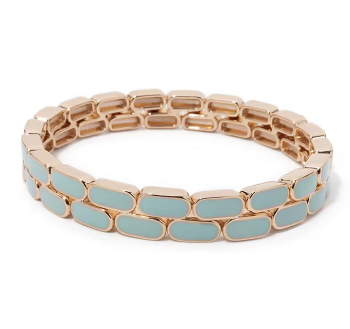 Bracelet with gold and light blue links on a white background
