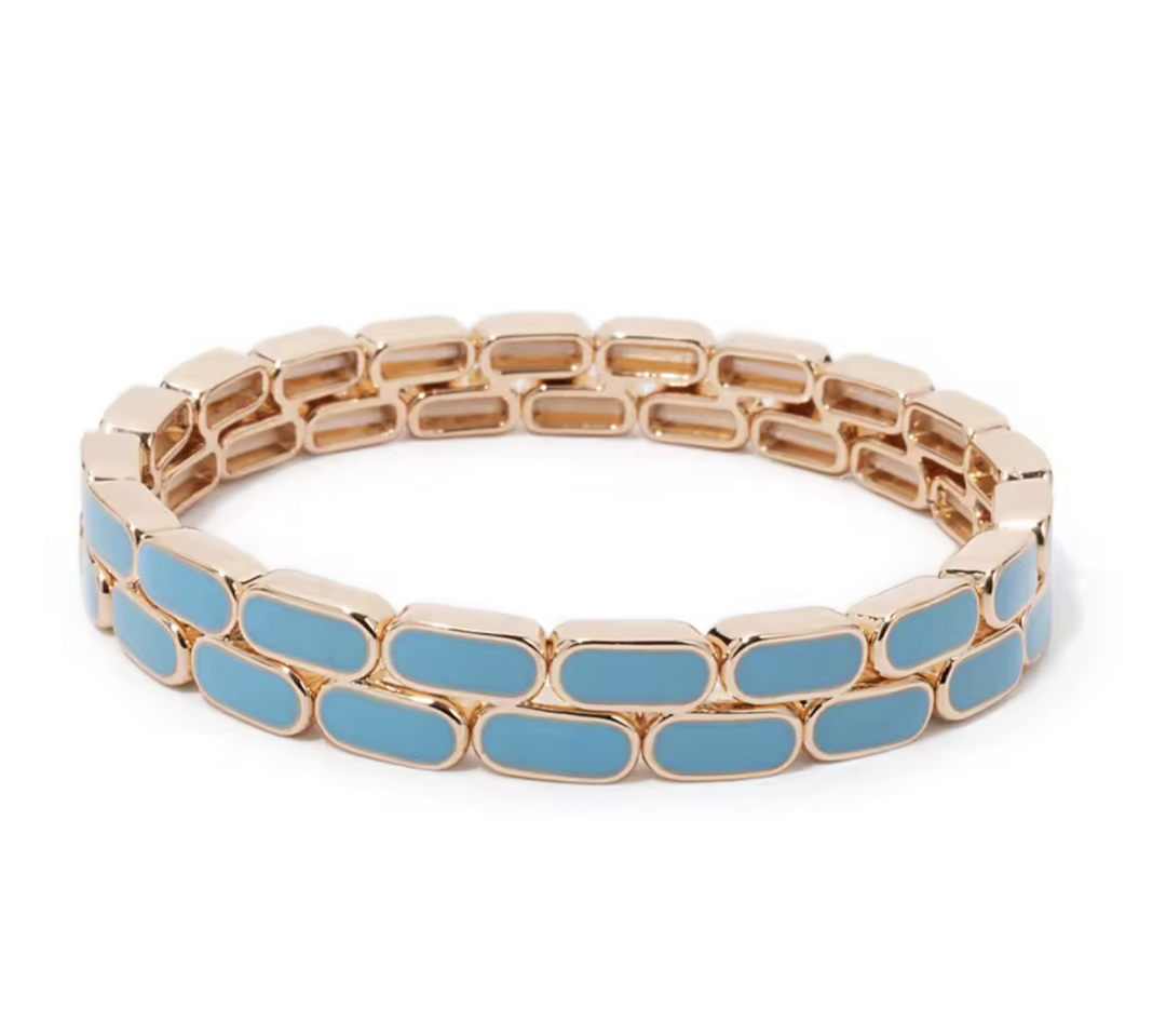 Bracelet with gold chain and blue oval links on a white background