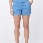 Person wearing light blue shorts on a white background