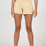 Beige shorts worn by a person on a white background