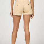 Beige shorts worn by a person on a white background