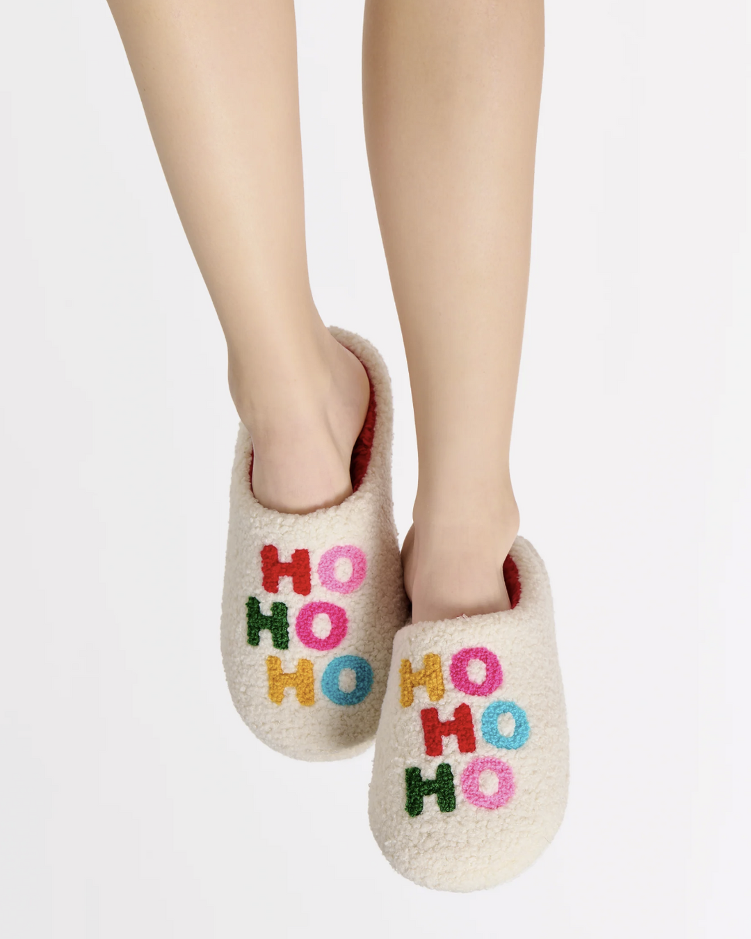 Beige slippers with 'HO HO HO' text on a white background