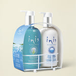 A two-piece hand care set from inis, featuring a blue Sea-Wash Hand Wash bottle and a white Sea-Sal Hand Lotion bottle, both in a white plastic caddy with a top handle.