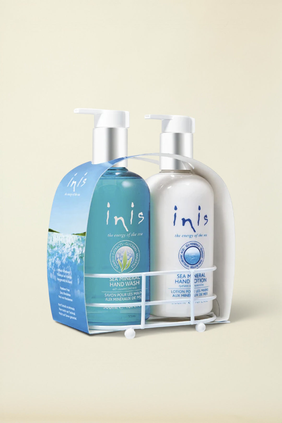 A two-piece hand care set from inis, featuring a blue Sea-Wash Hand Wash bottle and a white Sea-Sal Hand Lotion bottle, both in a white plastic caddy with a top handle.