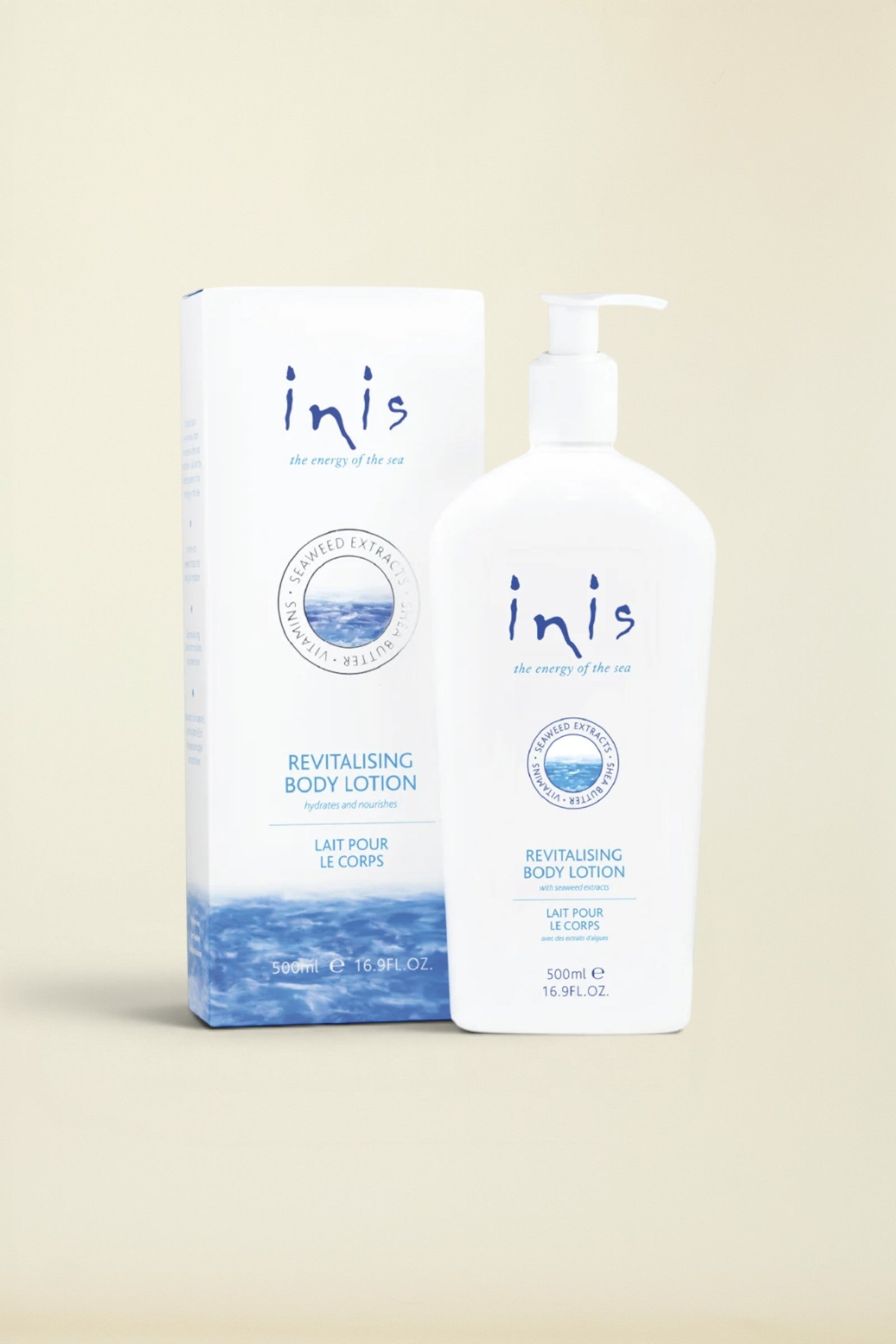 Inis Revitalising Body Lotion 500ml pump bottle next to its matching product packaging box, both in white with blue and navy branding and ocean wave graphics.