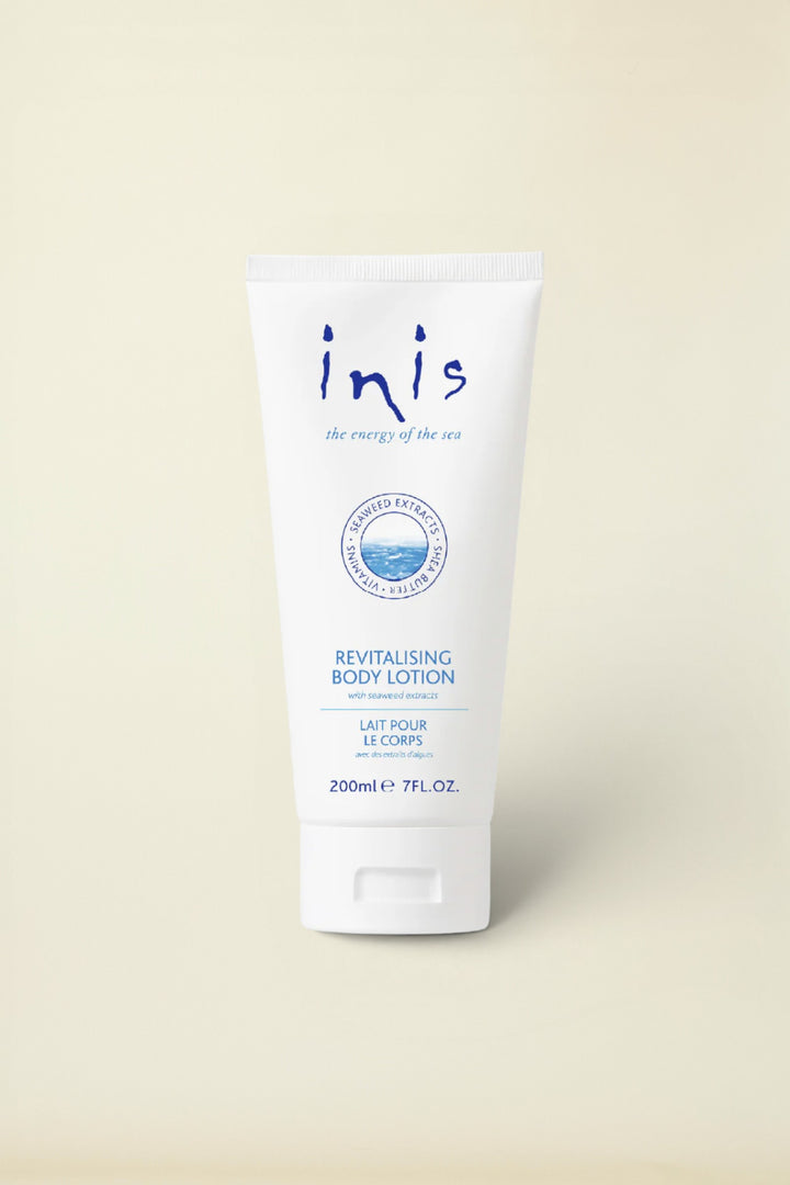 A white squeeze tube of Inis Revitalising Body Lotion with blue text and logo details, set against a clean white background with a soft shadow.