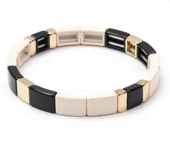 Bracelet with black and gold square links on a white background