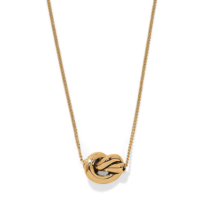 Gold necklace with a heart-shaped pendant on a white background