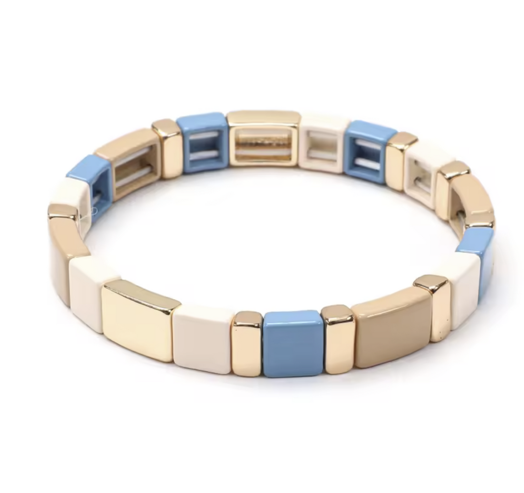 Bracelet with gold, blue, and beige square links on a white background