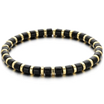 A black and gold colored bracelet with a simple pattern, made of enamel and gold-tone beads.