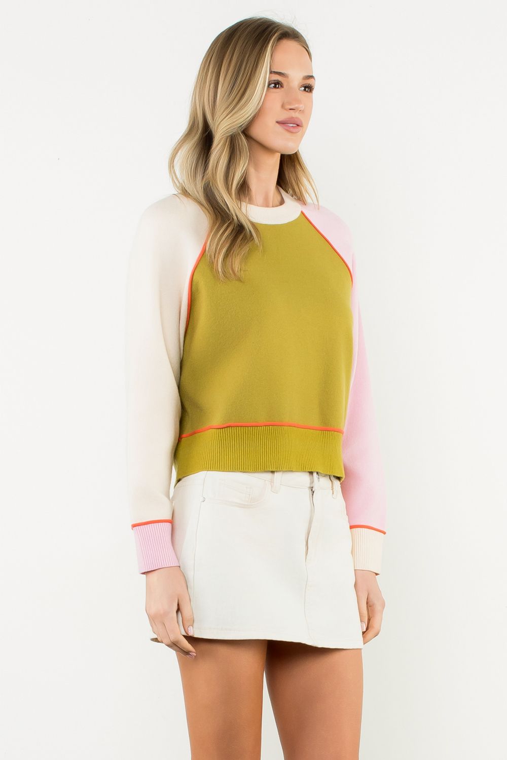 Lindsay sweater - Woman wearing a colorful sweater with a white background