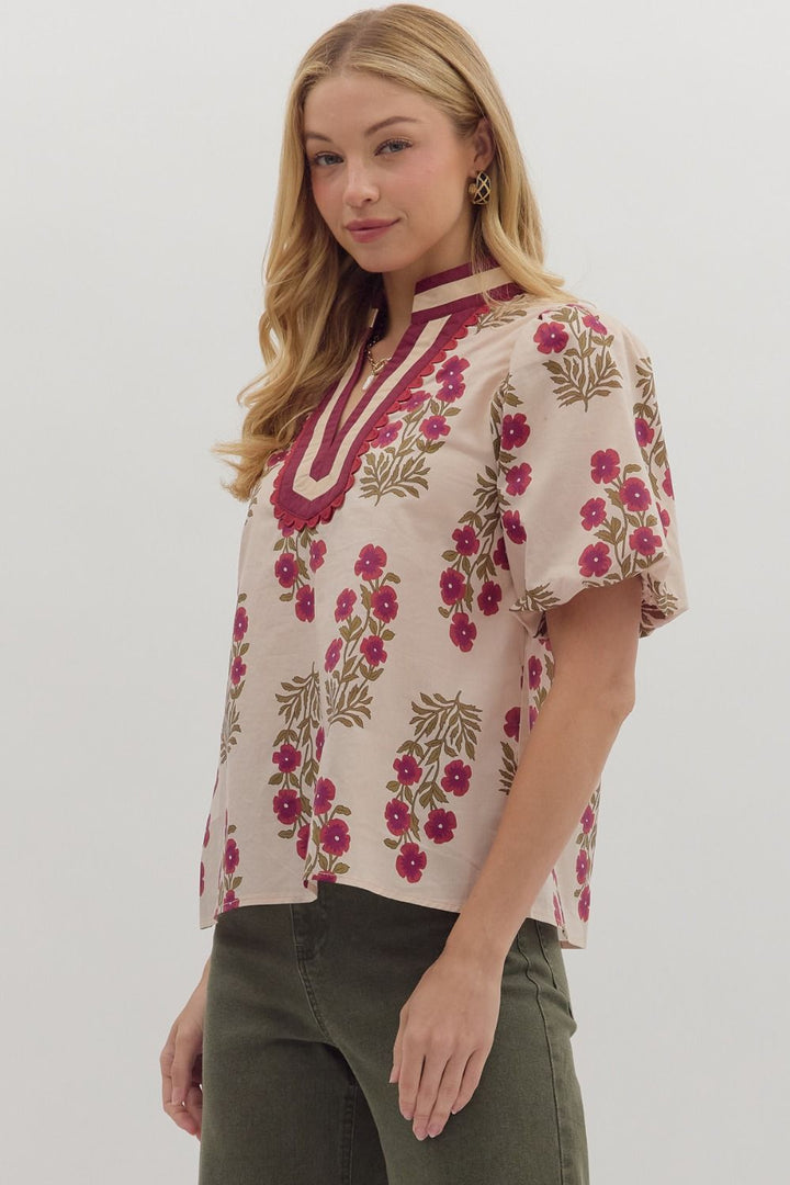 Woman wearing a floral blouse with a plain background