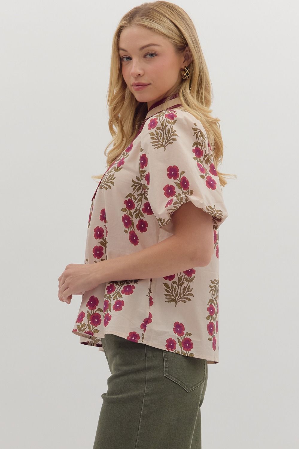 Woman wearing a floral blouse with a plain background