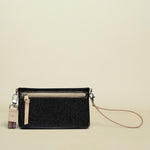 Black wristlet with a strap on a white background