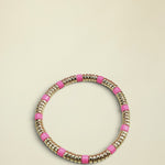 Bracelet with pink and gold beads on a white background