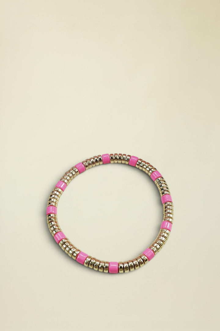 Bracelet with pink and gold beads on a white background