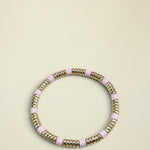 Bracelet with pink and gold beads on a light gray background