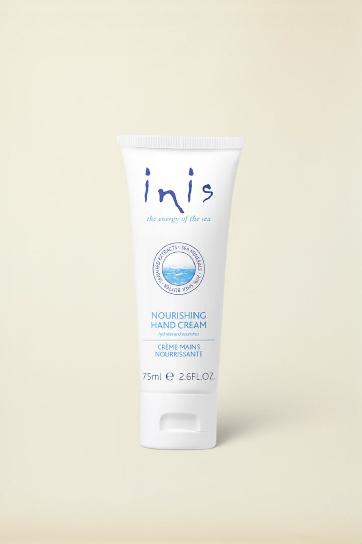 A white squeeze tube of Inis Nourishing Hand Cream with blue text and logo details, set against a clean white background.