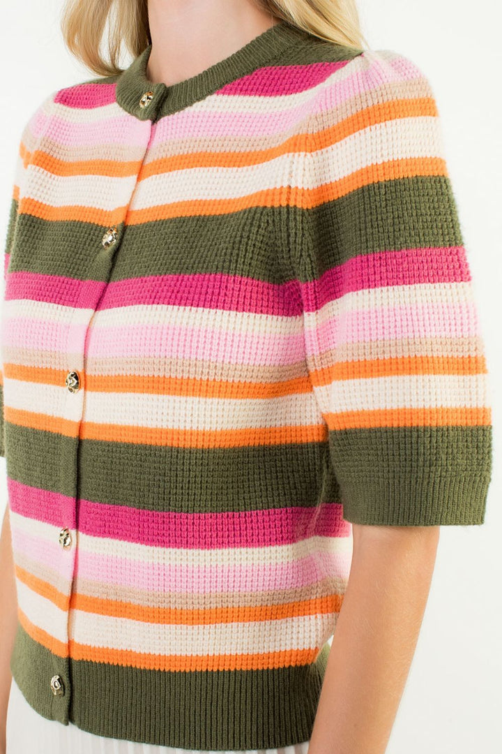 Colorful striped sweater with green trim worn by a person