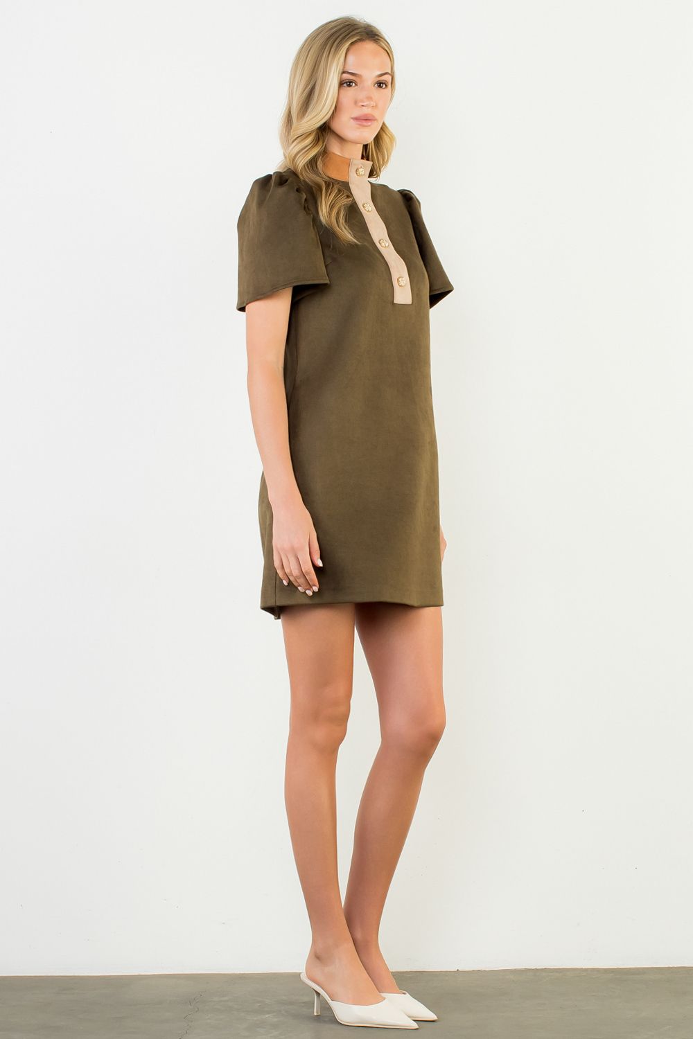 Woman wearing a green dress with a white background