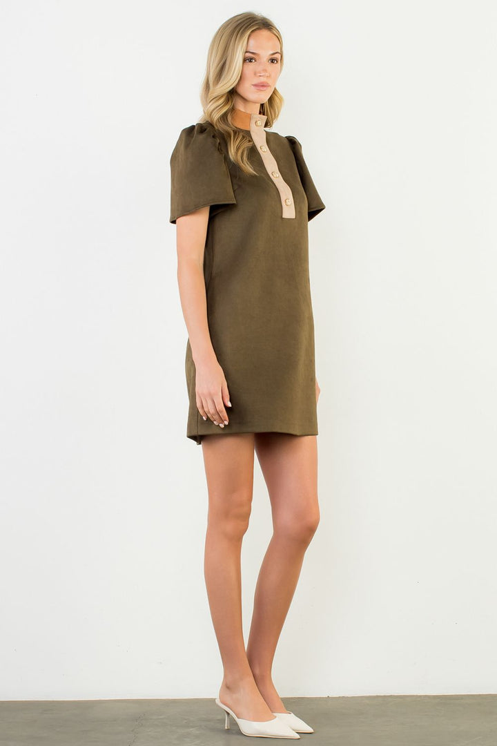 Woman wearing a green dress with a white background