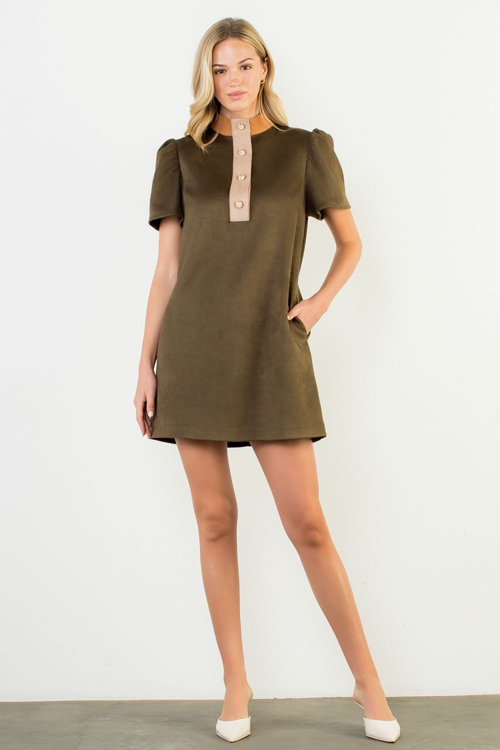 Woman wearing a green dress with a white background