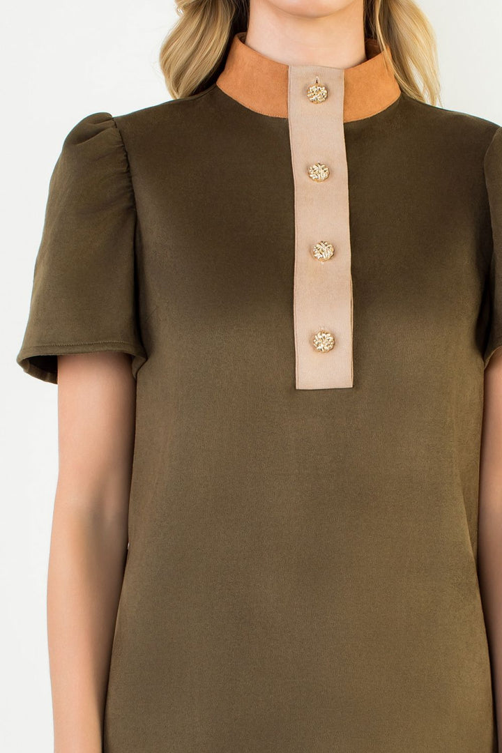 Green dress with beige collar and buttons on a white background