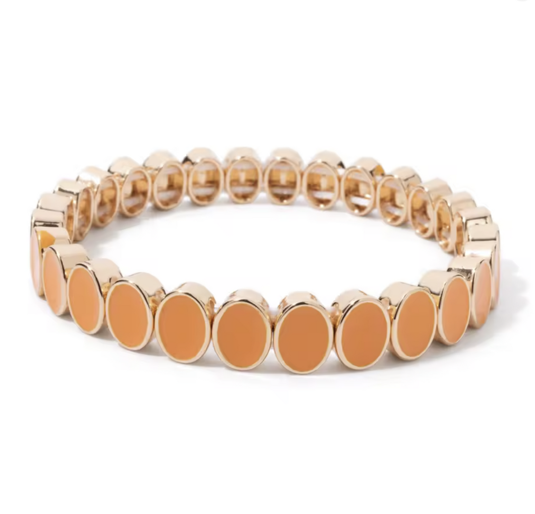 Bracelet with gold and orange beads on a white background