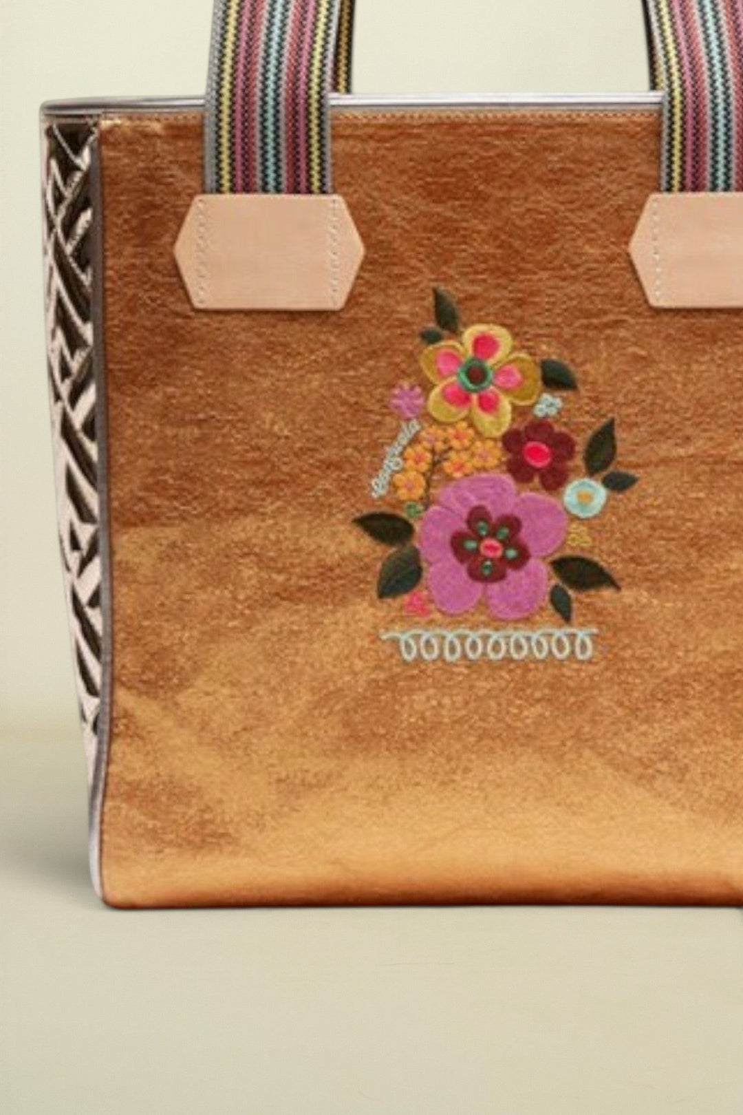 Point of Origin Consuela Bronzed Classic Tote with metallic finish, floral embroidery, and woven striped handles.