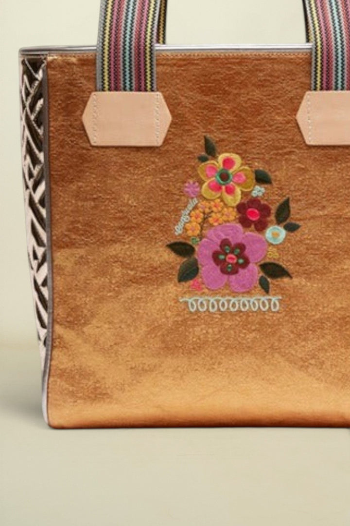 Point of Origin Consuela Bronzed Classic Tote with metallic finish, floral embroidery, and woven striped handles.