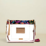Point of Origin Consuela clear crossbody bag with colorful Sophie print trim, natural leather accents, and woven strap.