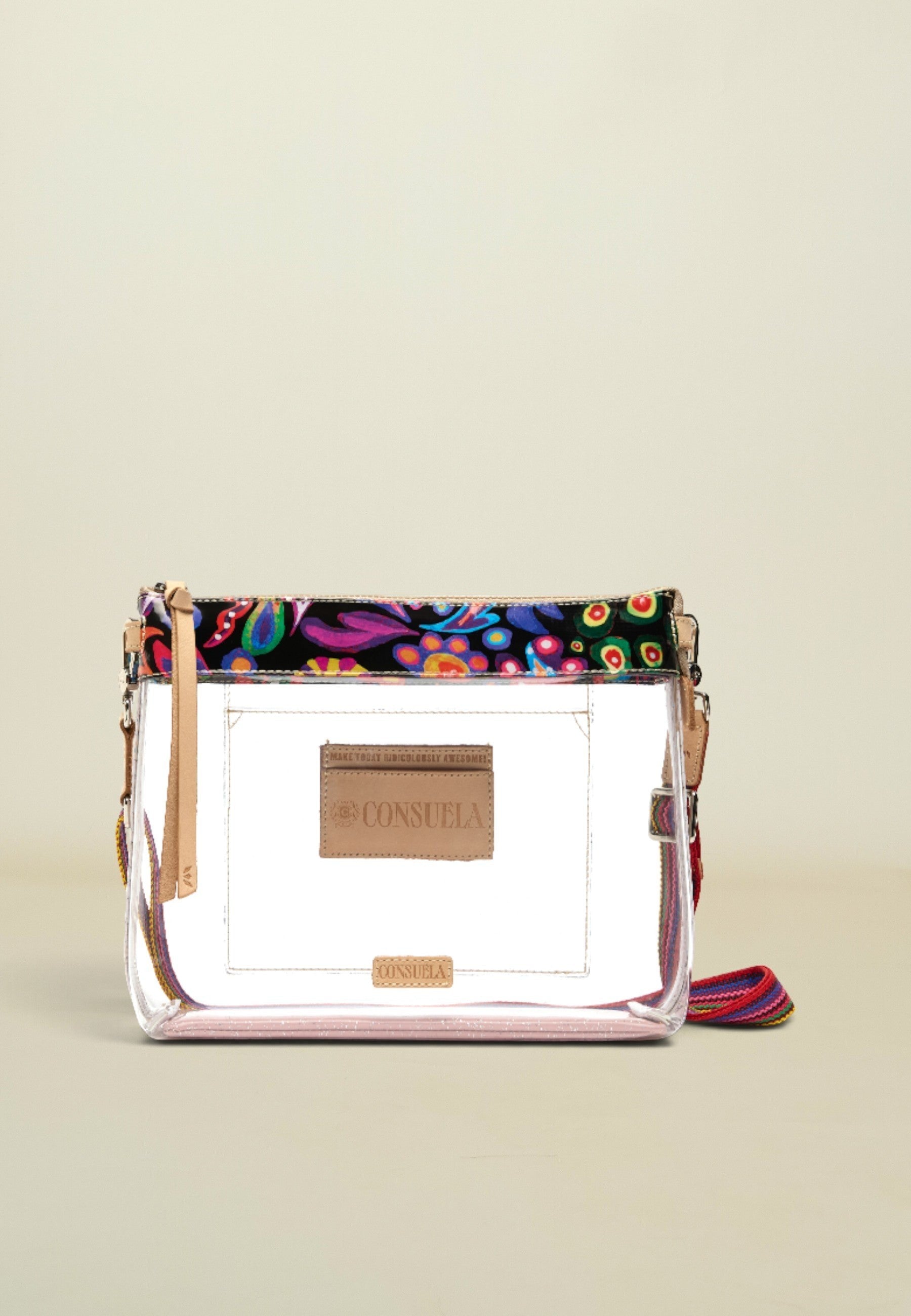 Point of Origin Consuela clear crossbody bag with colorful Sophie print trim, natural leather accents, and woven strap.