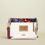 Point of Origin Consuela clear crossbody bag with colorful Sophie print trim, natural leather patch, and woven strap.