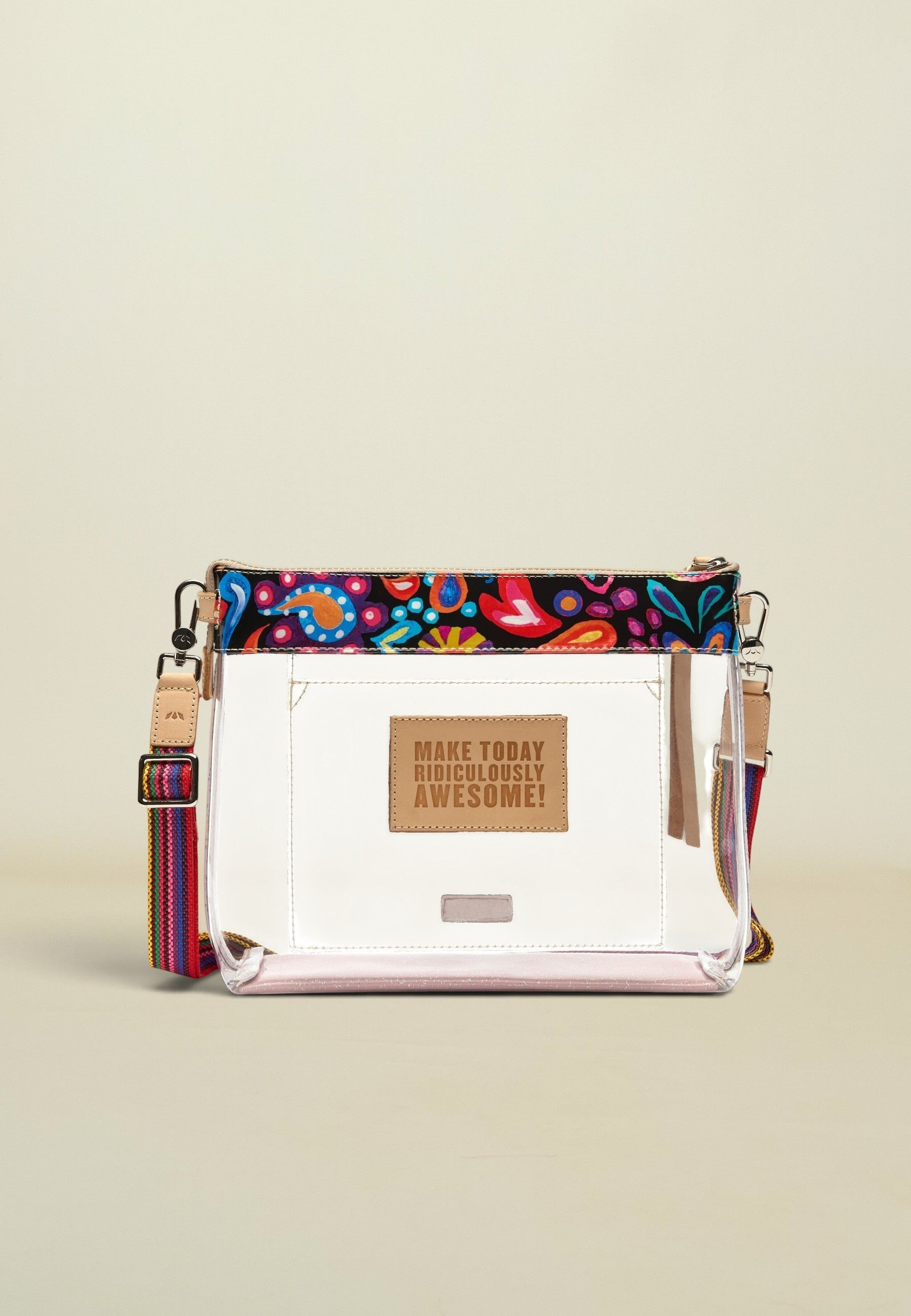 Point of Origin Consuela clear crossbody bag with colorful Sophie print trim, natural leather patch, and woven strap.