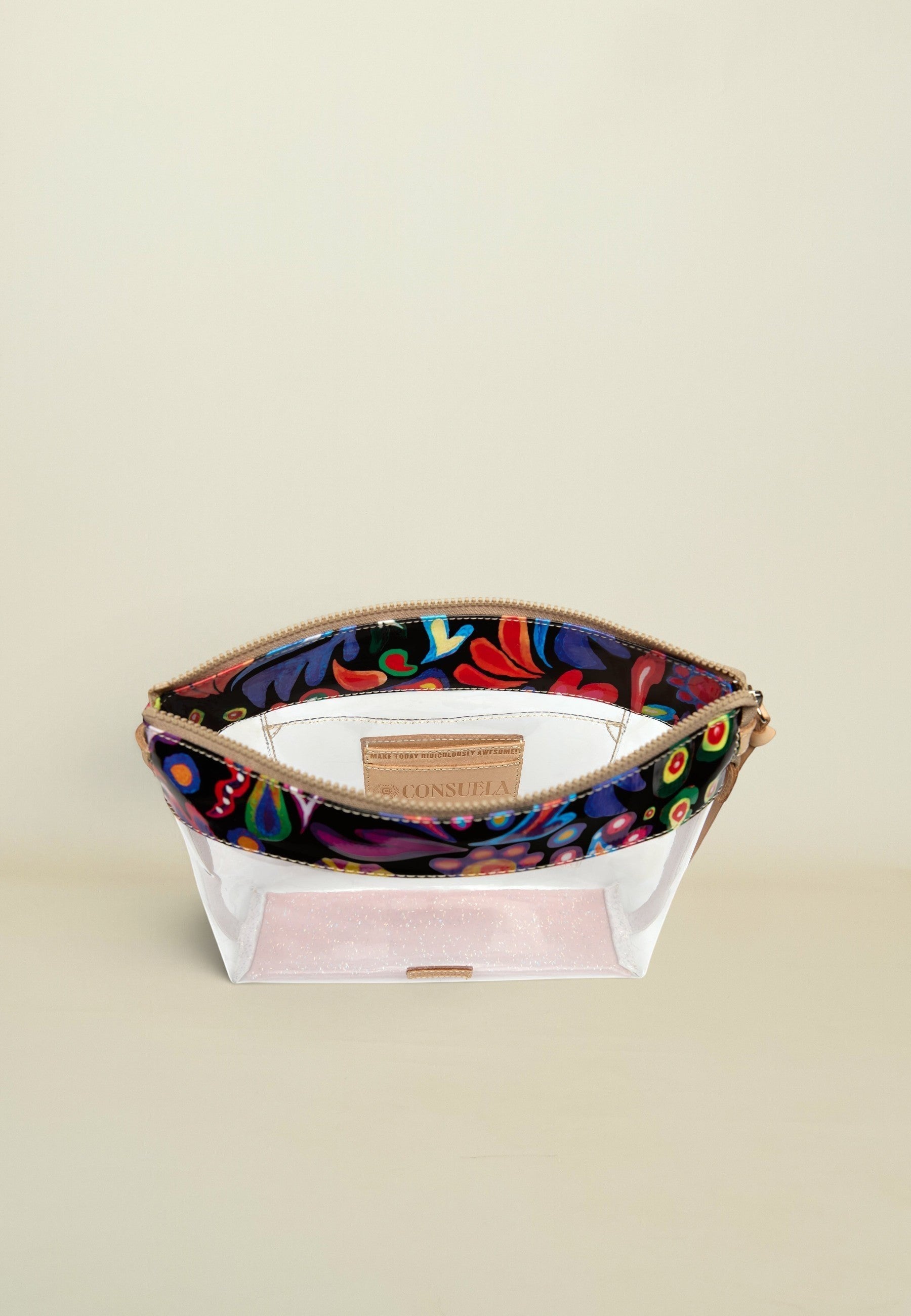 Point of Origin Consuela clear crossbody bag with a glitter base, floral Sophie print trim, and natural leather accents