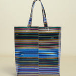 Point of Origin Consuela Hadley Basic Bag featuring a vibrant multi-colored horizontal striped pattern on vinyl