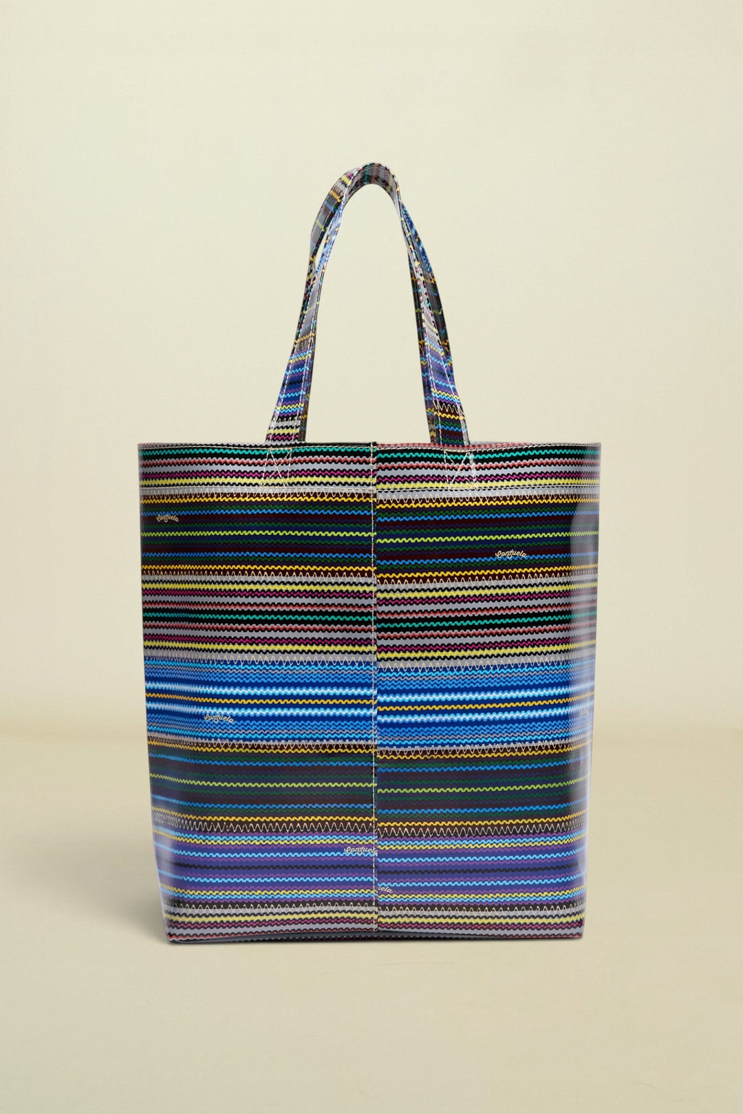 Point of Origin Consuela Hadley Basic Bag featuring a vibrant multi-colored horizontal striped pattern on vinyl
