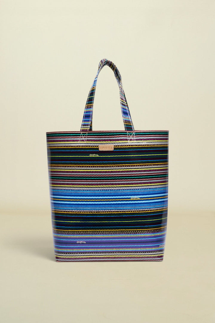 Point of Origin Consuela Hadley basic tote bag featuring a vibrant multi-colored horizontal striped pattern.