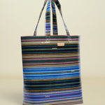 Point of Origin Consuela Hadley basic tote bag featuring a vibrant multi-colored horizontal striped pattern.