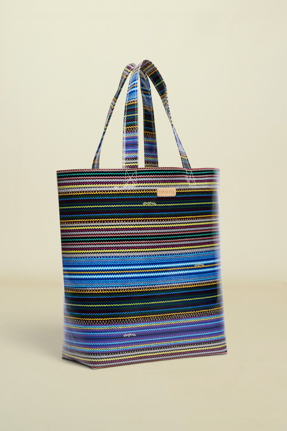 Point of Origin Consuela Hadley basic tote bag featuring a vibrant multi-colored horizontal striped pattern.